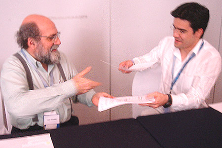 Demi Getshko (.br Administrative Contact) and Pablo Hinojosa from ICANN exchanging letters during LACTLD meeting in Isla Margarita, Venezuela.