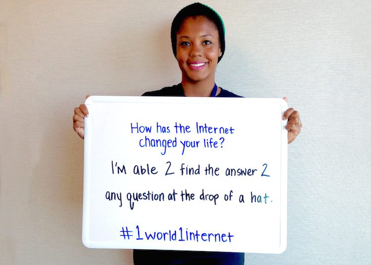 Shea Edwards holds a whiteboard, where she has written how the internet has changed her life
